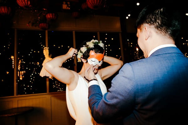 Bride putting on blindfold
