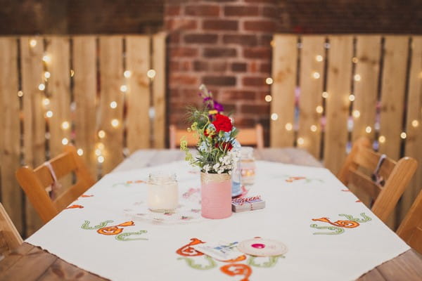 Table with small vase of flowers at wedding