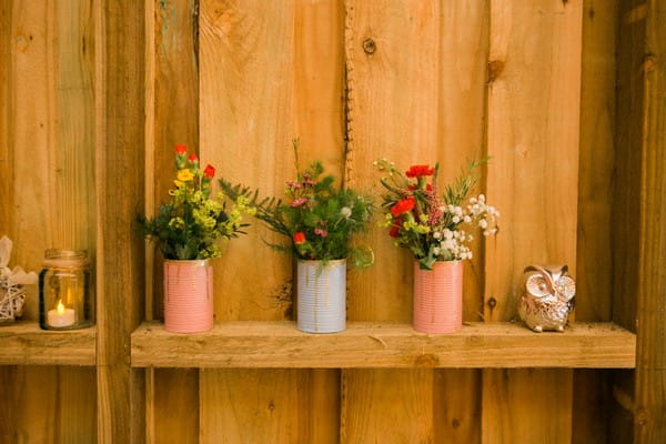 Pots of flowers on shelf at wedding