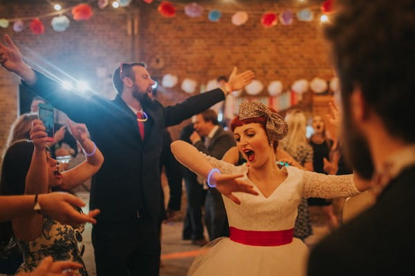 Bride and guests dancing having fun