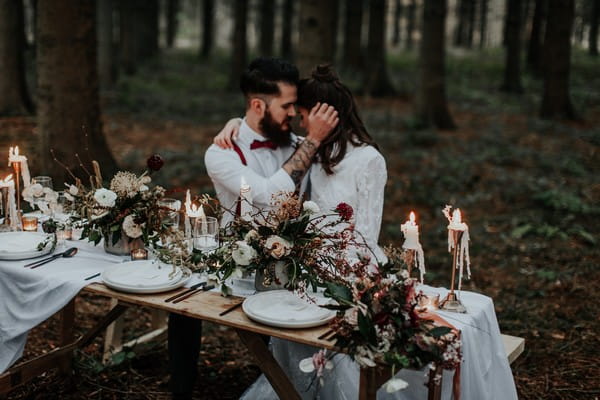 Couple sitting at naturally styled wedding table