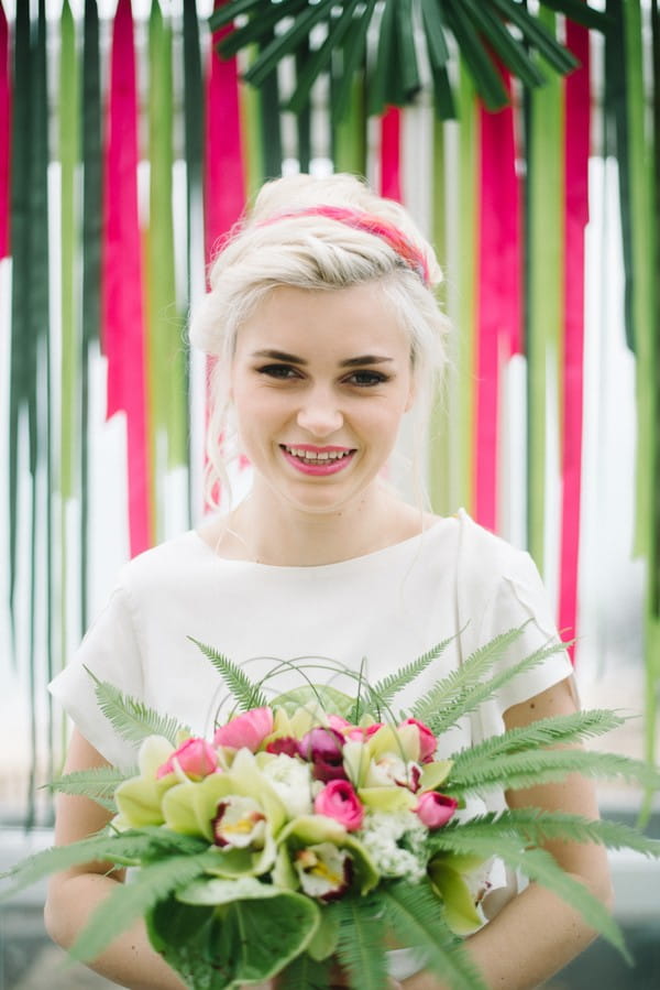 Bride holding colourful bouquet