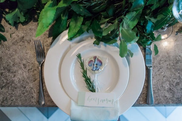 Wedding place setting with sprig of Rosemary