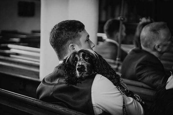 Dog resting head on owner's shoulder