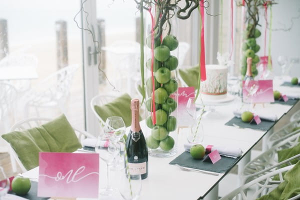 Pink and green details on wedding table