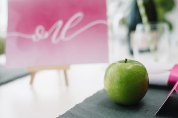 Green apple at wedding place setting