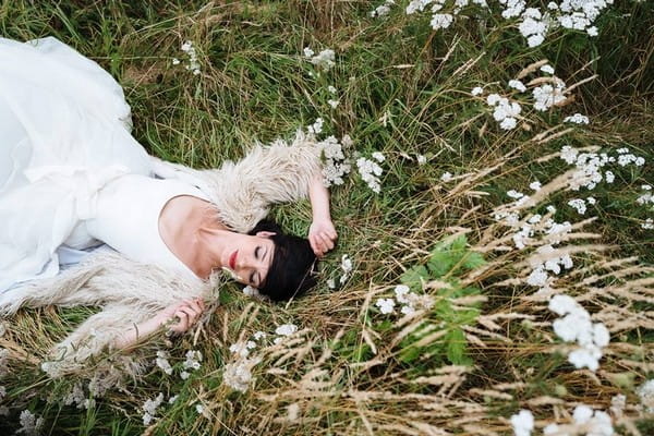 Bride laying in long grass - Picture by Nick Tucker Photography