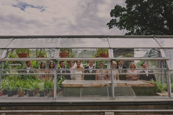 Bridal party standing in greenhouse - Picture by Lottie Elizabeth Photography