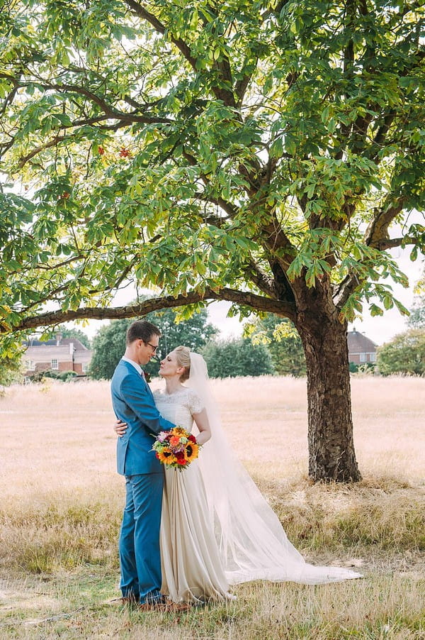 Bride and groom under tree