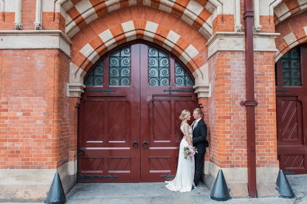 Bride and groom in large doorway