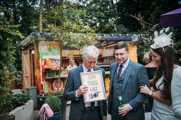 Wedding guest holding gin sign