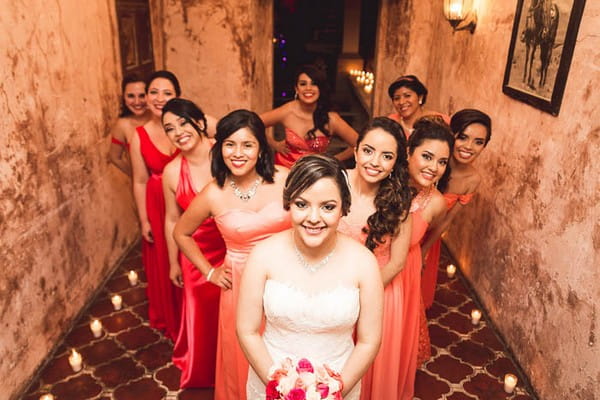 Bride and bridesmaids standing in a V shape