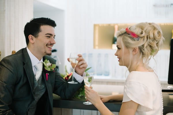 Bride and groom having drinks at bar