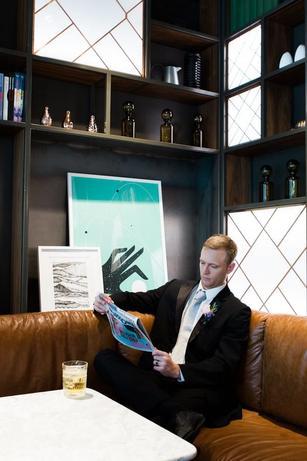 Groom reading newspaper