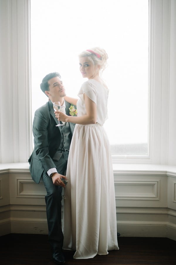 Bride and groom by window