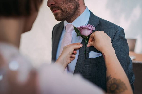 Buttonhole being pinned to suit