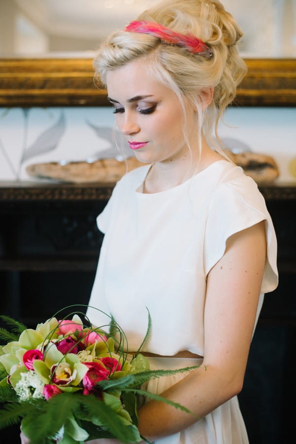 Bride looking down at bouquet