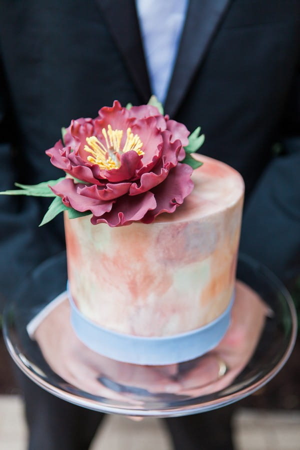 Flower on top of watercolour wedding cake