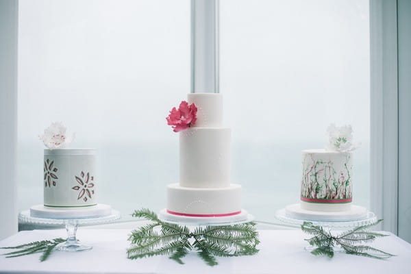 Three wedding cakes on table