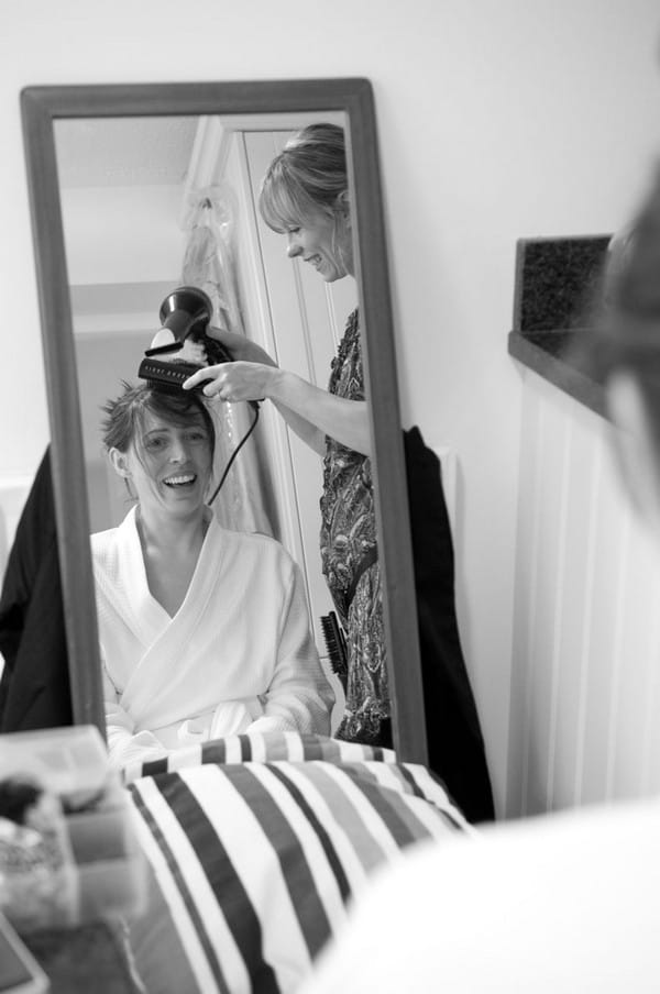 Bride having front of hair blow-dried after washing