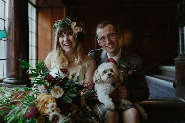 Bride and groom sitting with dog on groom's lap - Picture by Rooftop Mosaic