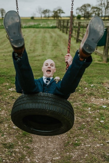 Groom on tyre swing - Picture by Daniel Ackerley Photography