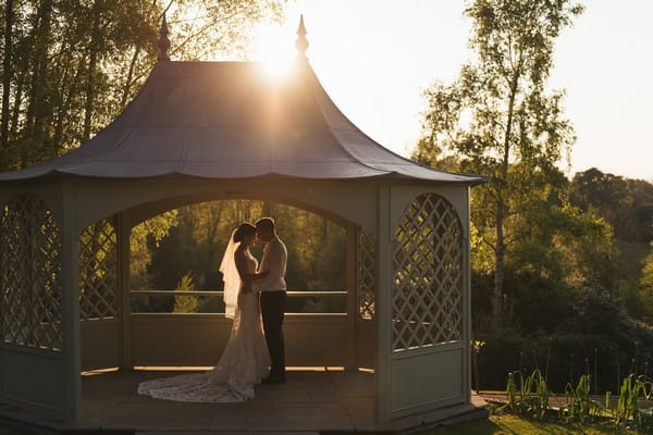 Bride and groom in gazebo at wedding venue - Picture by Penny Young Photography