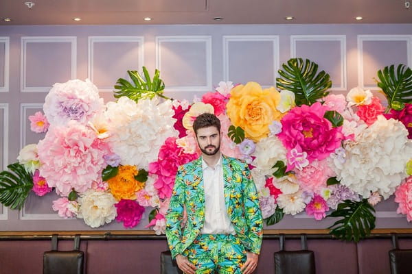 Groom wearing bright tropical style suit
