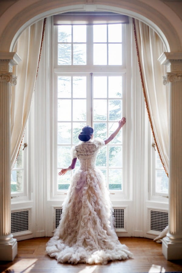 Bride standing at window at Hedsor House