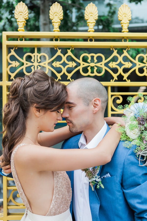 Bride with arms around groom's neck