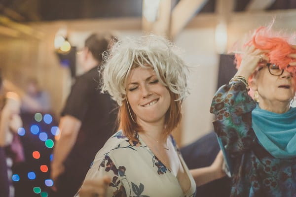 Wedding guest dancing with wig on