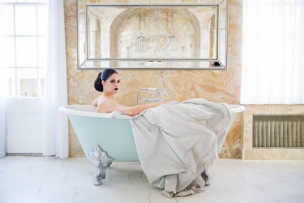 Bride sitting in bath tub