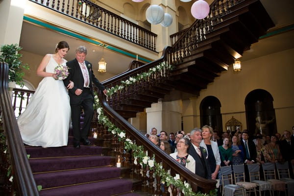 Father walking bride down stairs at Kings Weston House