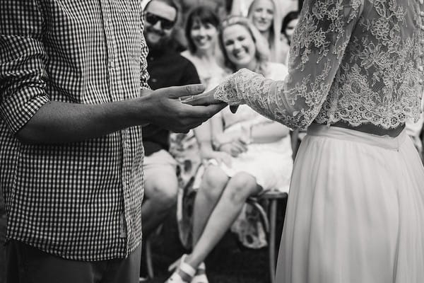Groom holding bride's hand