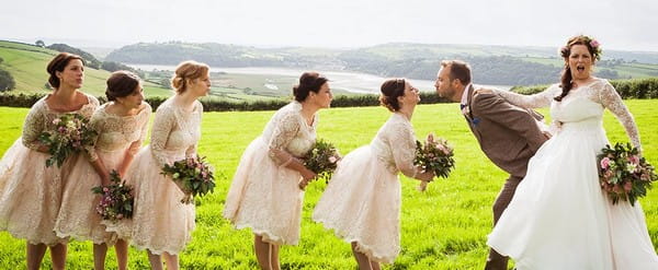 Bridesmaids in a queue to kiss groom - Picture by Paola De Paola Photography