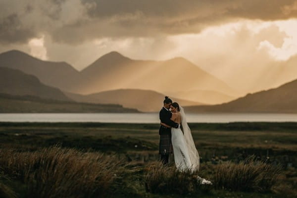 Bride and groom with Scottish hills in background - Picture by John Johnston Photography