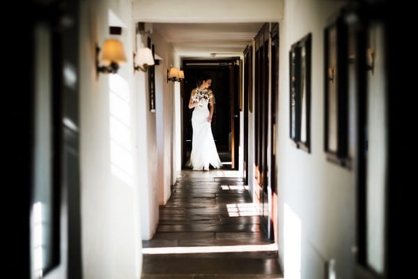 Bride standing in corridor of wedding venue - Picture by Dale Stephens Photography