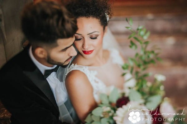 Bride sitting on groom's lap - Picture by Laura Calderwood Photography