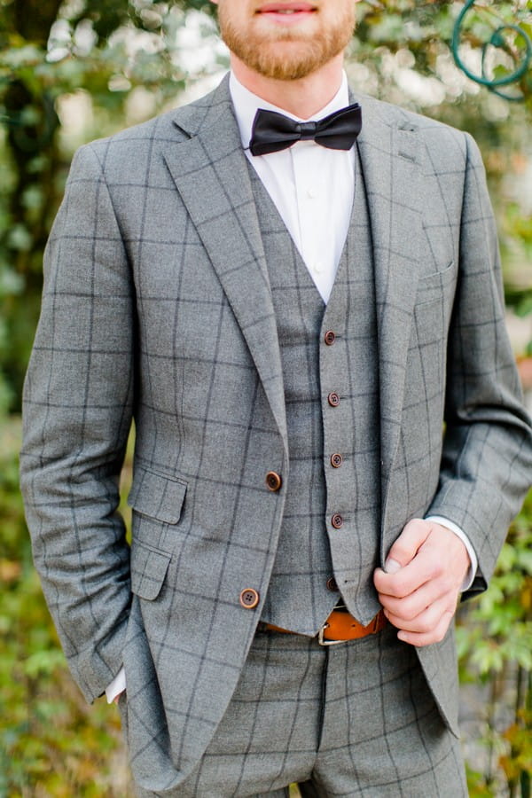 Groom wearing grey check jacket and waistcoat