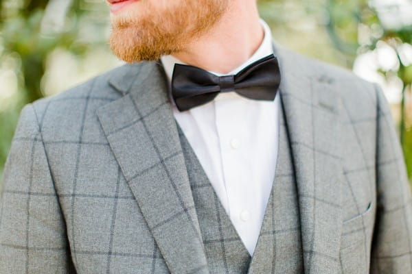 Groom wearing black bow tie