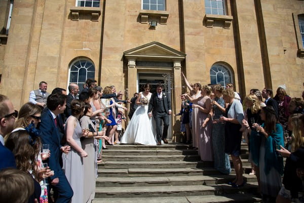 Bride and groom walking down steps outside Kings Weston House