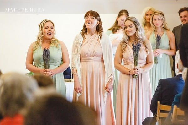 Bridesmaids singing in wedding ceremony