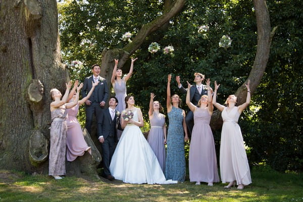Bridesmaids throwing bouquets in the air