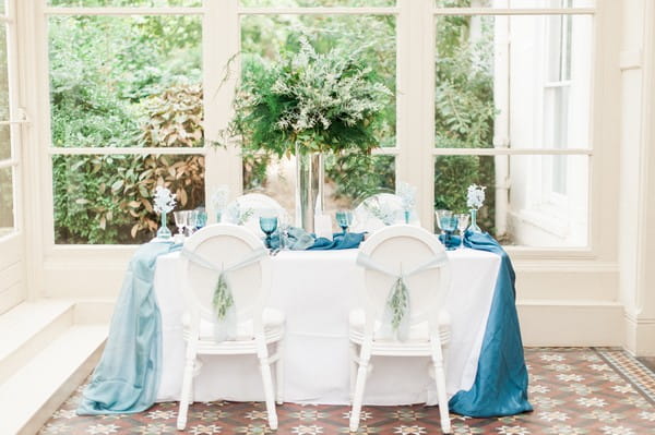 Wedding table with blue silk runner