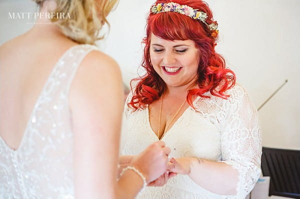 Bride putting ring on bride's finger