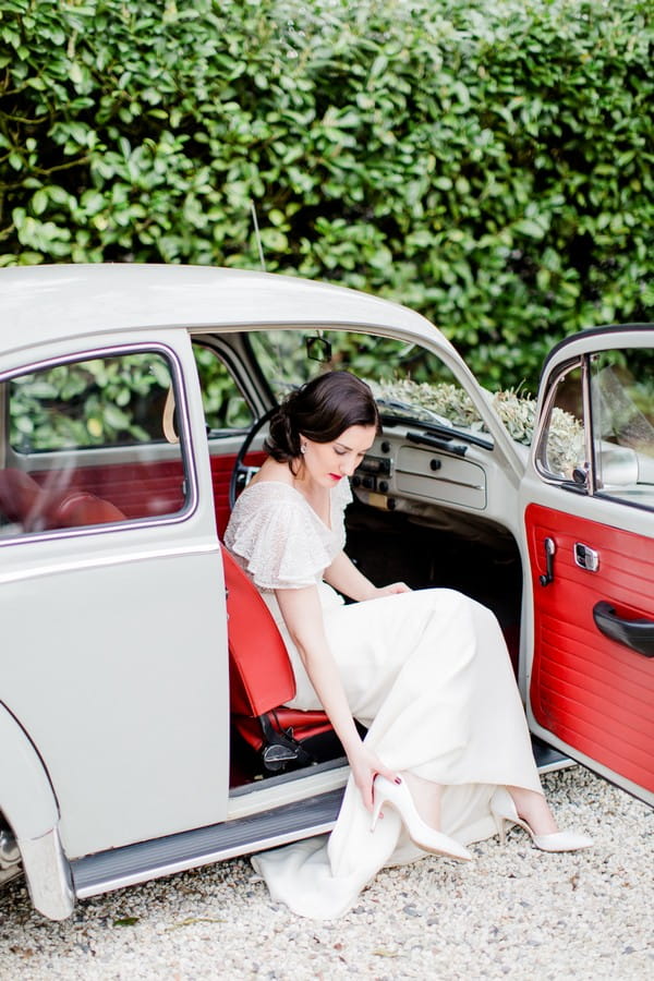 Bride sitting in vintage VW Beetle