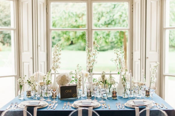 Vases of white flowers on wedding table