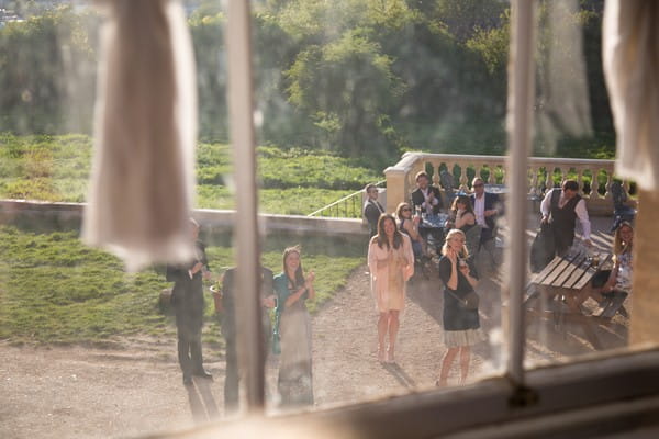 Wedding guests seen through window