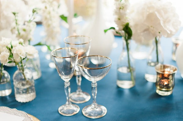 Glasses with gold rims on wedding table