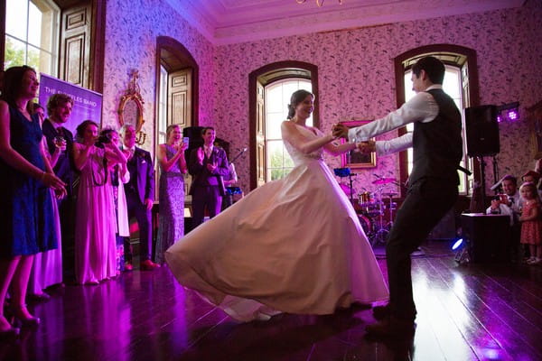 Bride and groom spinning round on dance floor at Kings Weston House